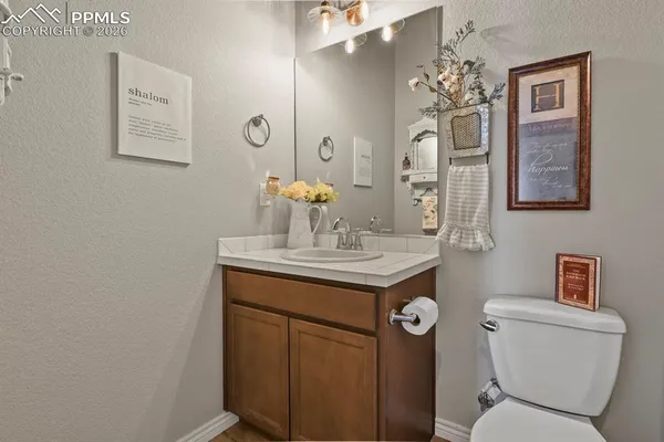 a bathroom with a toilet a sink and mirror