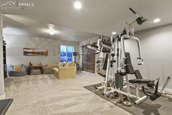 a room with gym equipment and view of living room