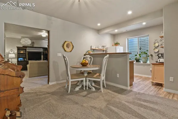 a living room with furniture a dining table and a fireplace