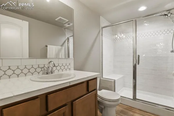 a bathroom with a sink toilet and shower
