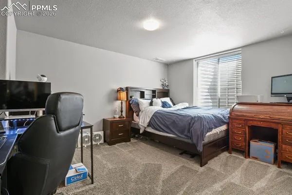 a bedroom with a bed and a chair