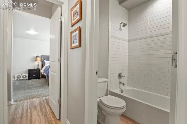 a bathroom with a granite countertop toilet a sink and a bathtub