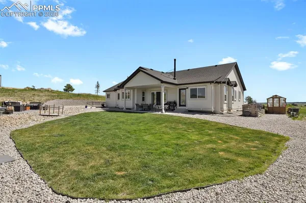 a view of a house with a backyard porch and sitting area
