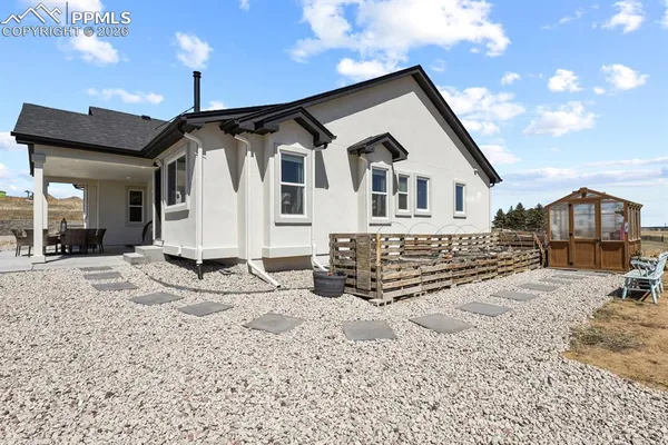 a front view of a house with a yard covered in snow
