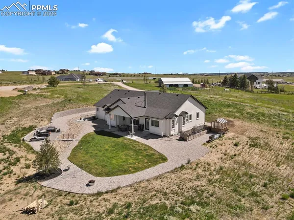 an aerial view of a house with big yard