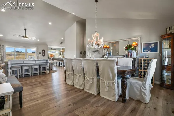 a dining room with furniture entryway and wooden floor