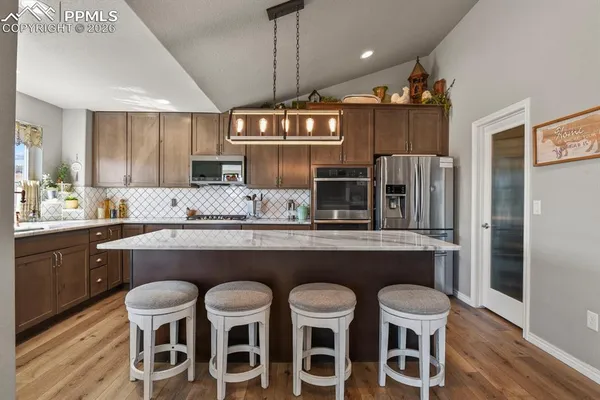 a kitchen with a table and chairs in it