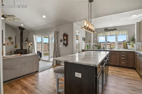 a kitchen with counter top space sink and center island