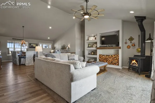 a living room with fireplace furniture and a flat screen tv