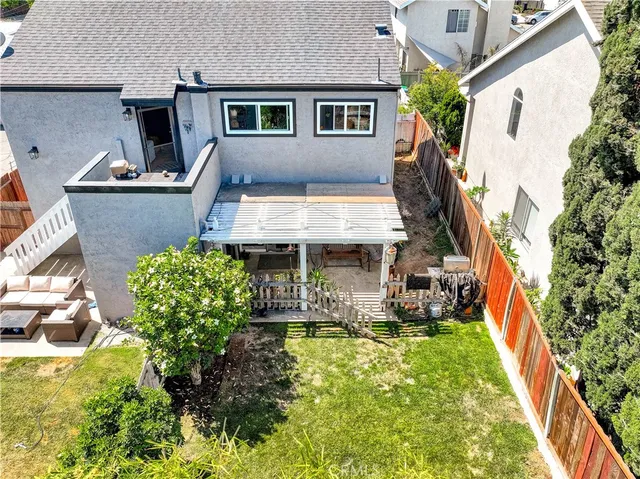 an aerial view of a house with swimming pool garden and patio