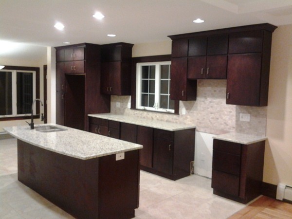 7 St Elmo Road Worcester, MA 01602 - Photo 9 of 17 a kitchen with kitchen island granite countertop a sink and a refrigerator
