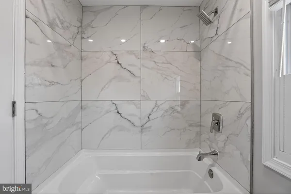 a bathroom with a granite countertop sink toilet and mirror