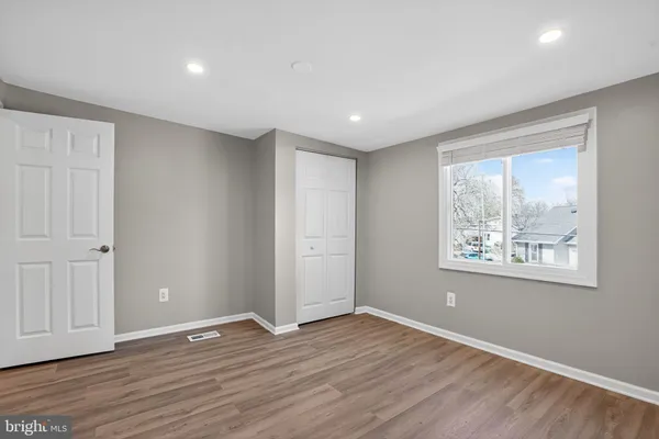 an empty room with wooden floor