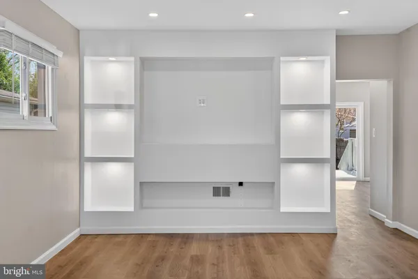 a view of empty room with wooden floor