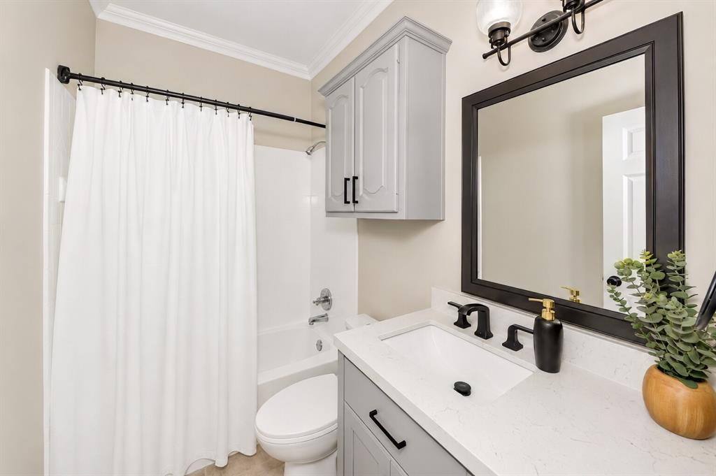 3817 Ganzer Road West Denton, TX 76207 - Photo 10 of 40 This full downstairs bathroom sits near the garage entry and just steps from the backyard door, making it easy for guests or anyone coming in from outside. Its location next to the downstairs bedroom — and close to the kitchen — creates a convenient setup for multi-generational living or a private guest space. It’s a smart, accessible bathroom that fits the flow of everyday life.
