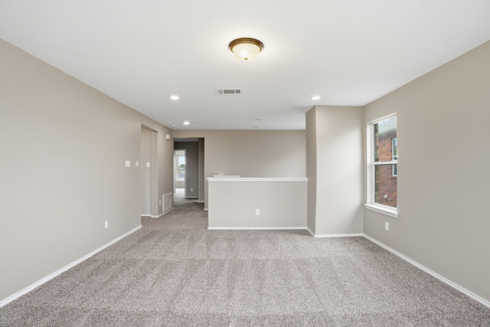 670 Landon Samuel Loop Pflugerville, TX 78660 - Photo 15 of 22 Spacious carpeted room featuring neutral wall tones, recessed lighting, and a single window with white trim