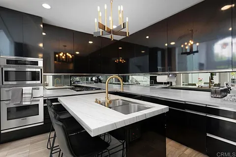 a kitchen with a sink and a refrigerator