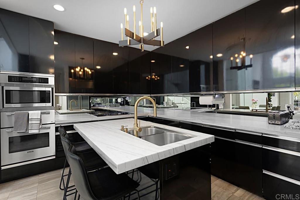 7429 Via De Fortuna Carlsbad, CA 92009 - Photo 13 of 47 a kitchen with a sink a counter space appliances and cabinets