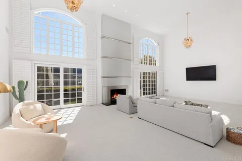 a living room with furniture fireplace and flat screen tv