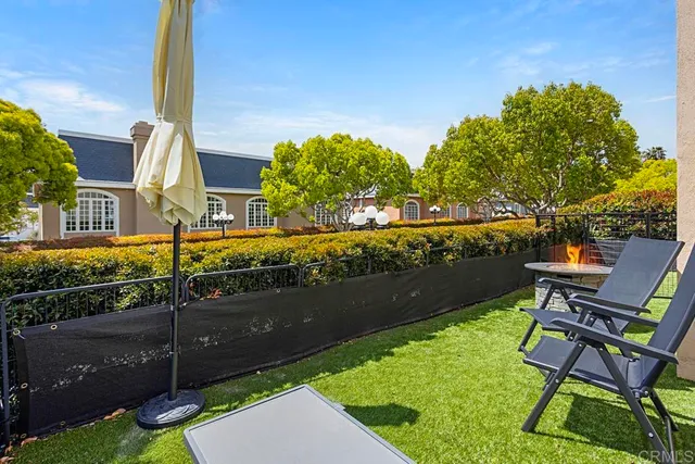 a view of a house with backyard and sitting area