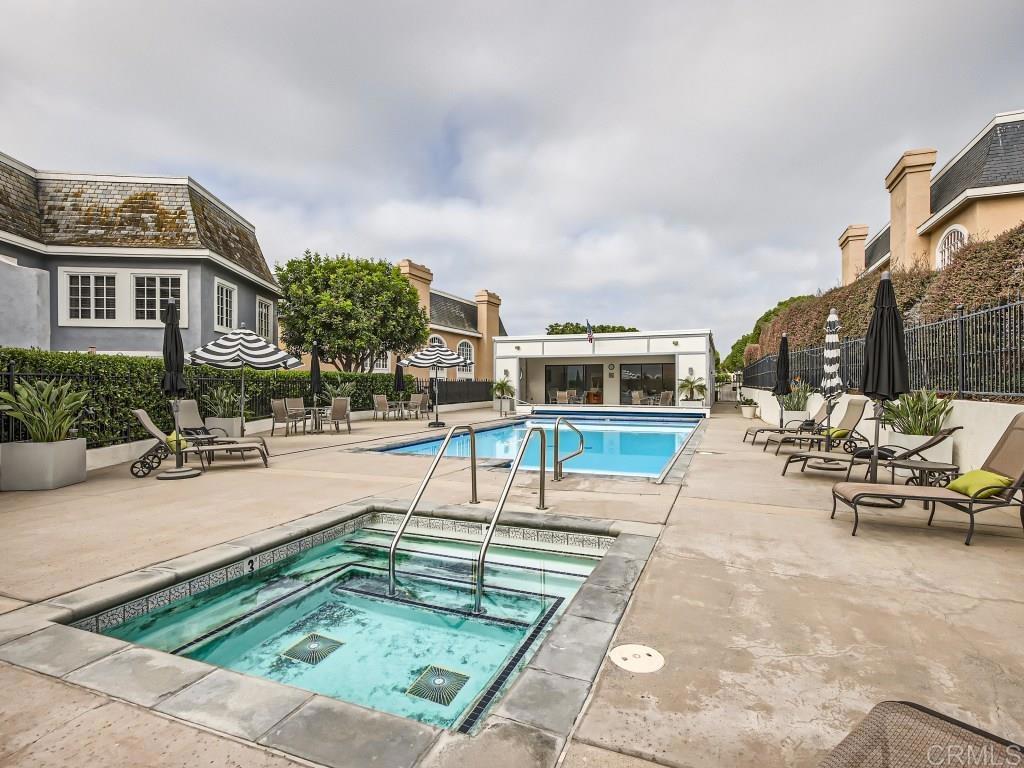 7429 Via De Fortuna Carlsbad, CA 92009 - Photo 6 of 47 a swimming pool with outdoor seating and barbeque oven