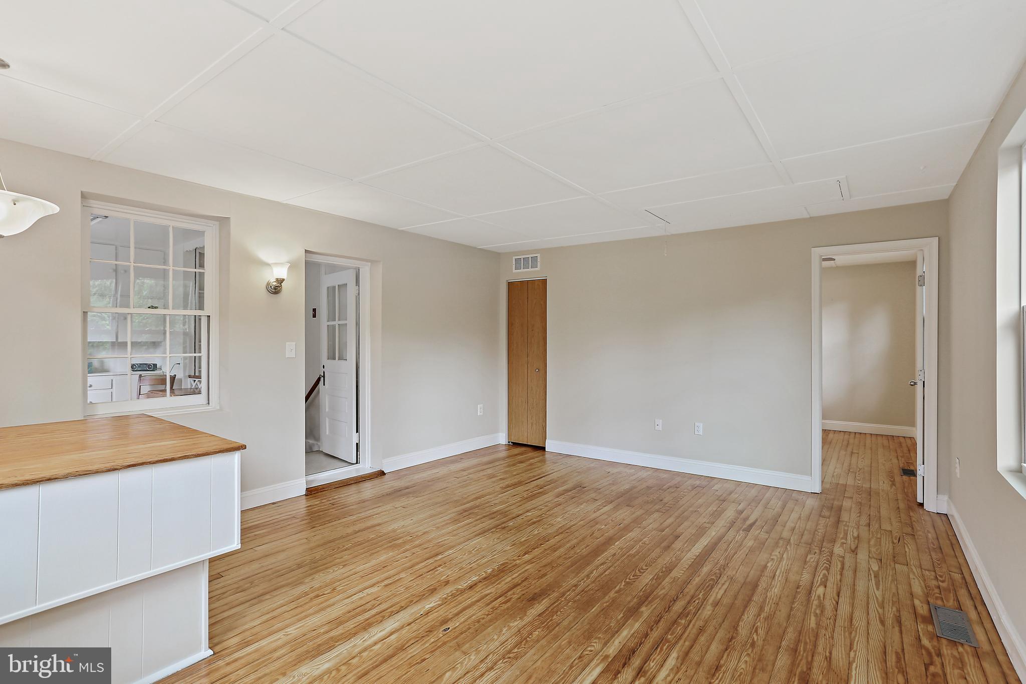 1813 Frederick Road Catonsville, MD 21228 - Photo 9 of 19 wooden floor in an empty room with a window