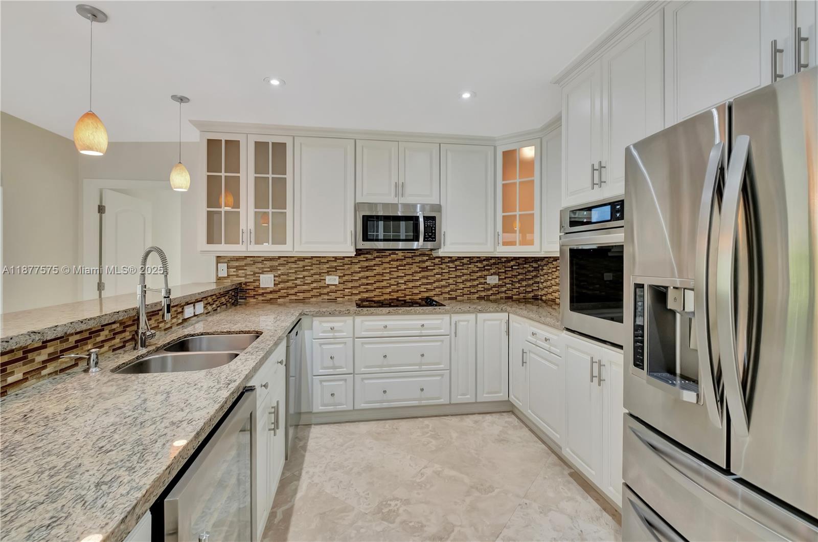 200 Harbor Drive Key Biscayne, FL 33149 - Photo 12 of 16 a kitchen with granite countertop a sink stove and refrigerator