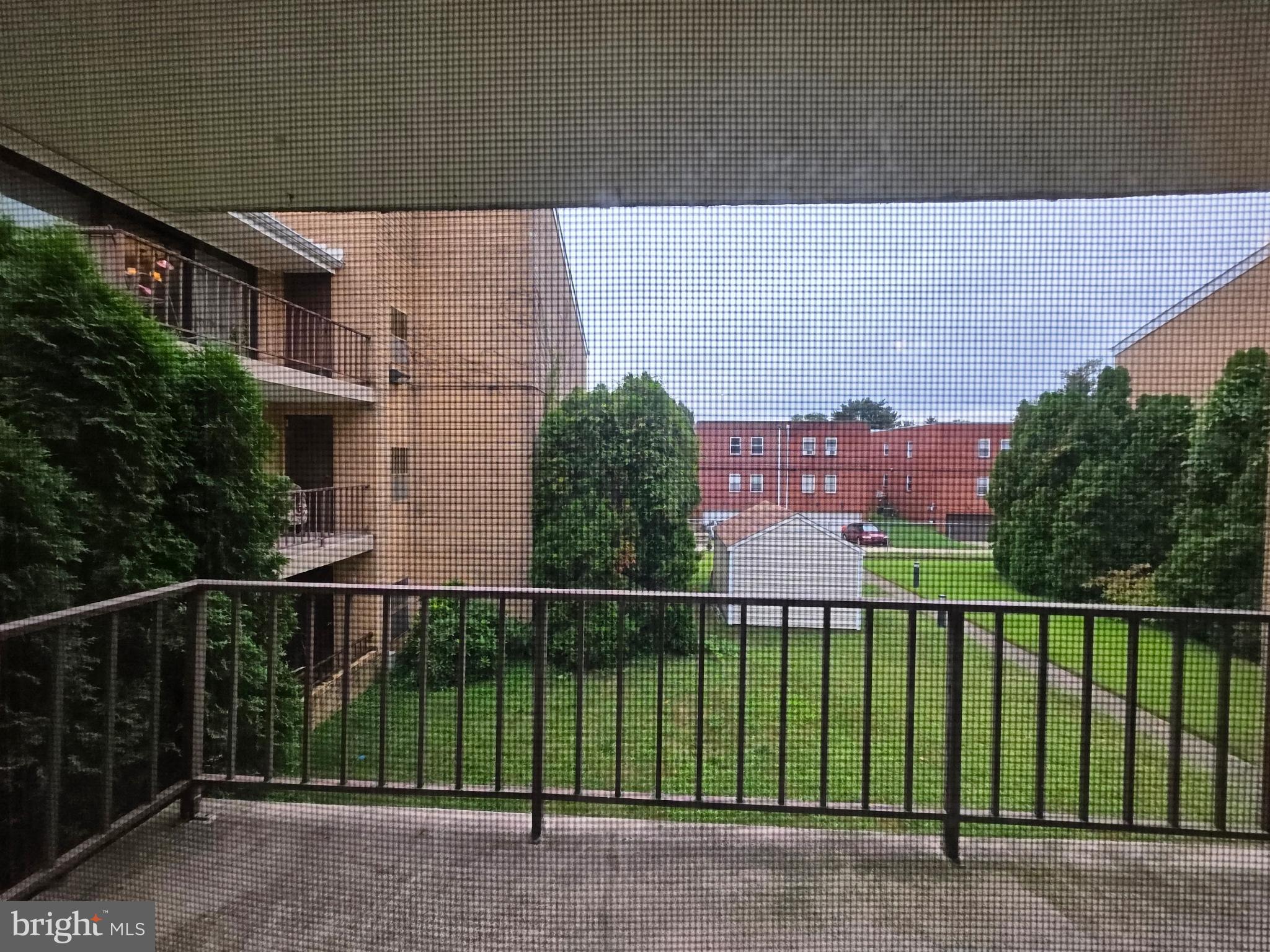 8950 Krewstown Road, Unit 204 Philadelphia, PA 19115 - Photo 8 of 15 Serene balcony view of lush greenery.