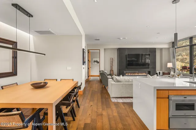a large kitchen with kitchen island a large window and stainless steel appliances