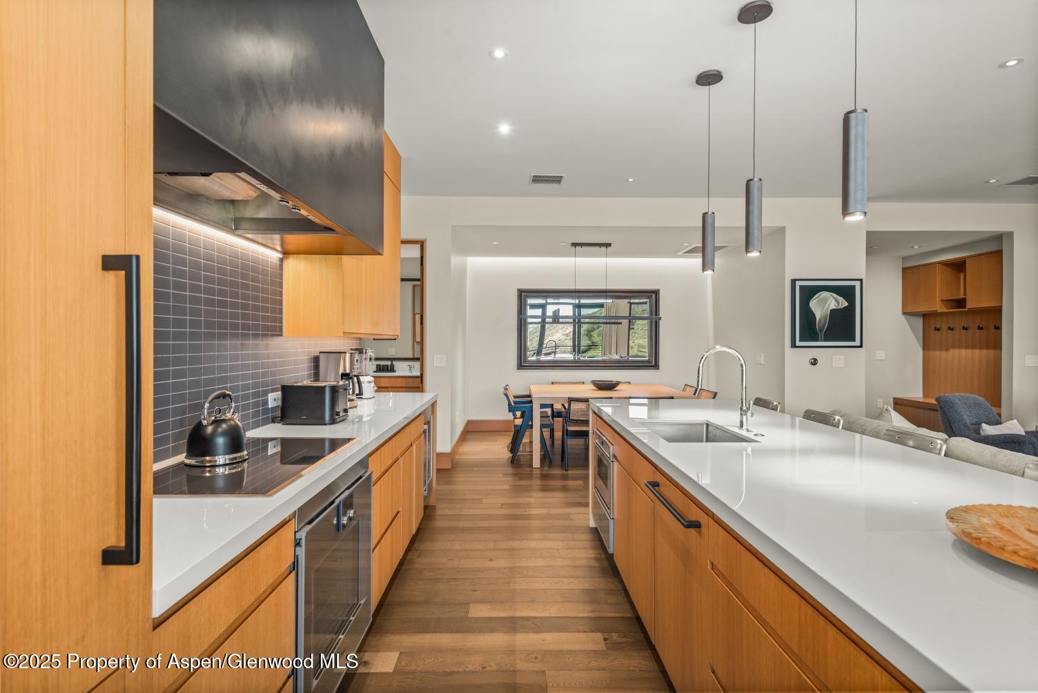 77 Wood Road, Unit 603 Snowmass Village, CO 81615 - Photo 14 of 45 a large kitchen with kitchen island a large window and stainless steel appliances