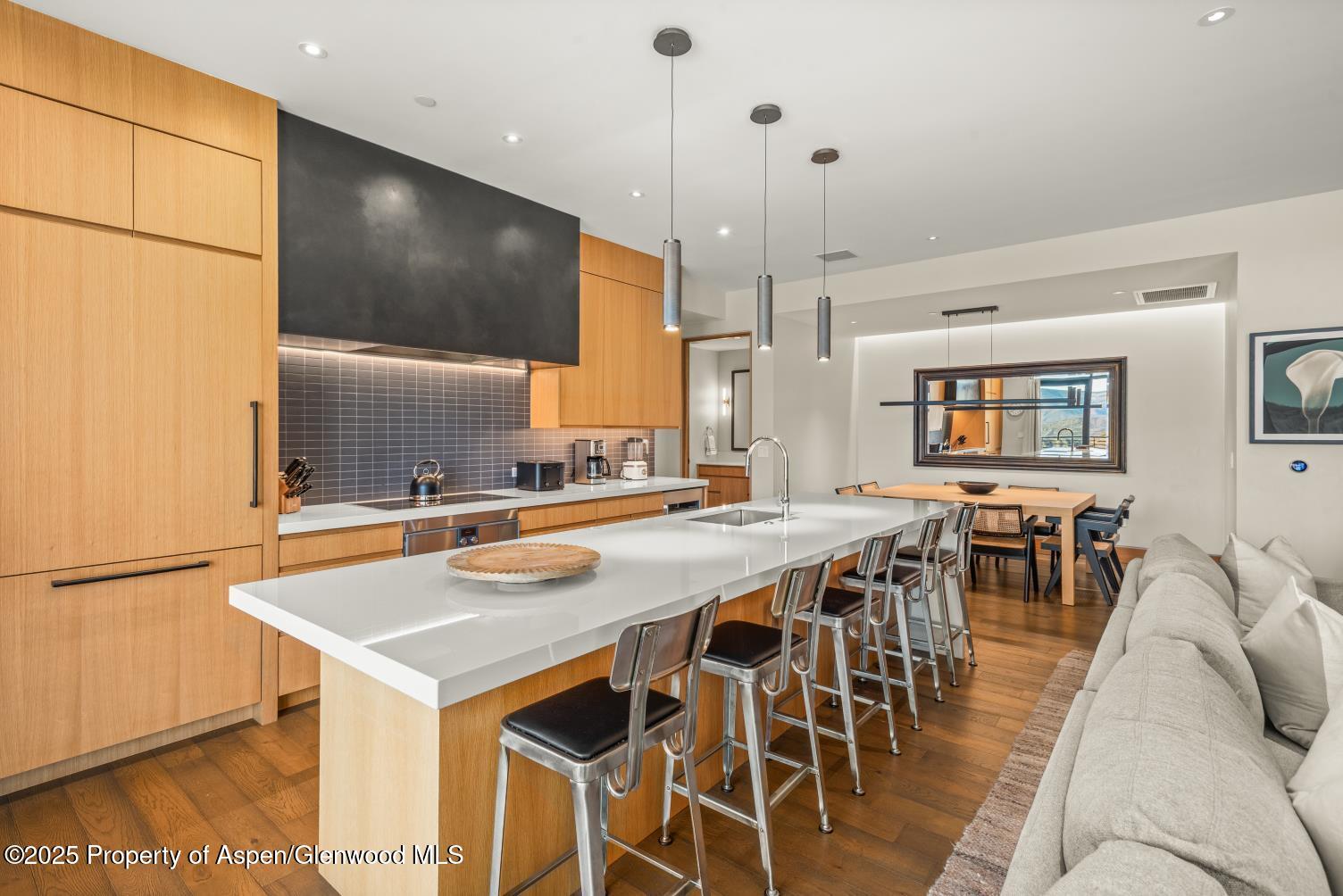 77 Wood Road, Unit 603 Snowmass Village, CO 81615 - Photo 15 of 45 a kitchen with stainless steel appliances granite countertop a table chairs sink and cabinets