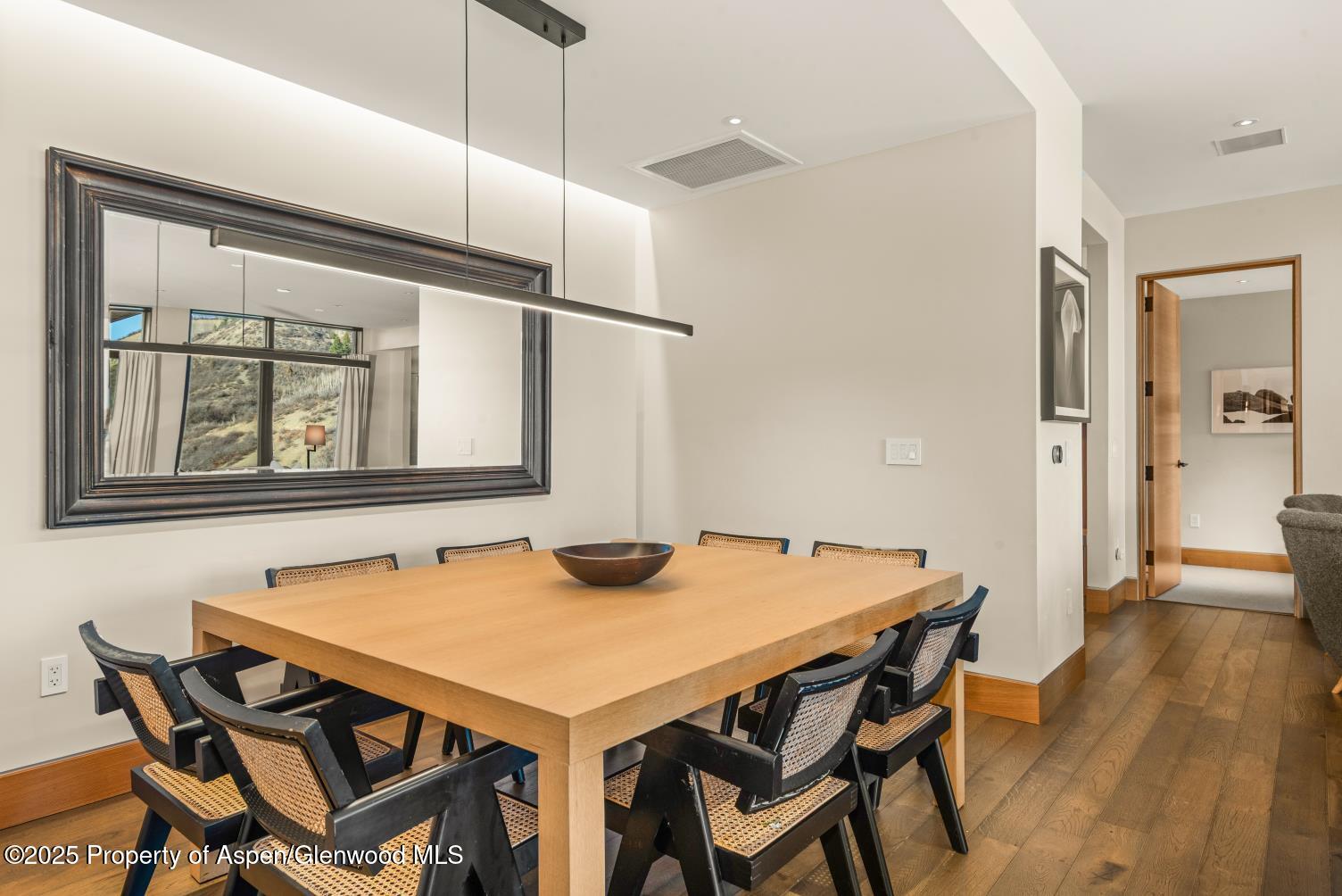 77 Wood Road, Unit 603 Snowmass Village, CO 81615 - Photo 16 of 45 a view of a dining room with furniture and wooden floor