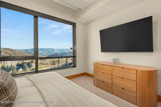 a bedroom with a large bed and a large window