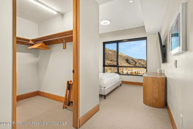 a bedroom with a large bed and a large window