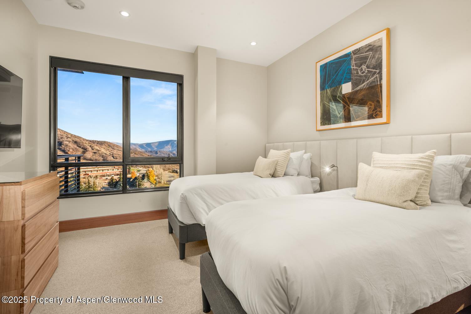 77 Wood Road, Unit 603 Snowmass Village, CO 81615 - Photo 23 of 45 a bedroom with a large bed and a large window