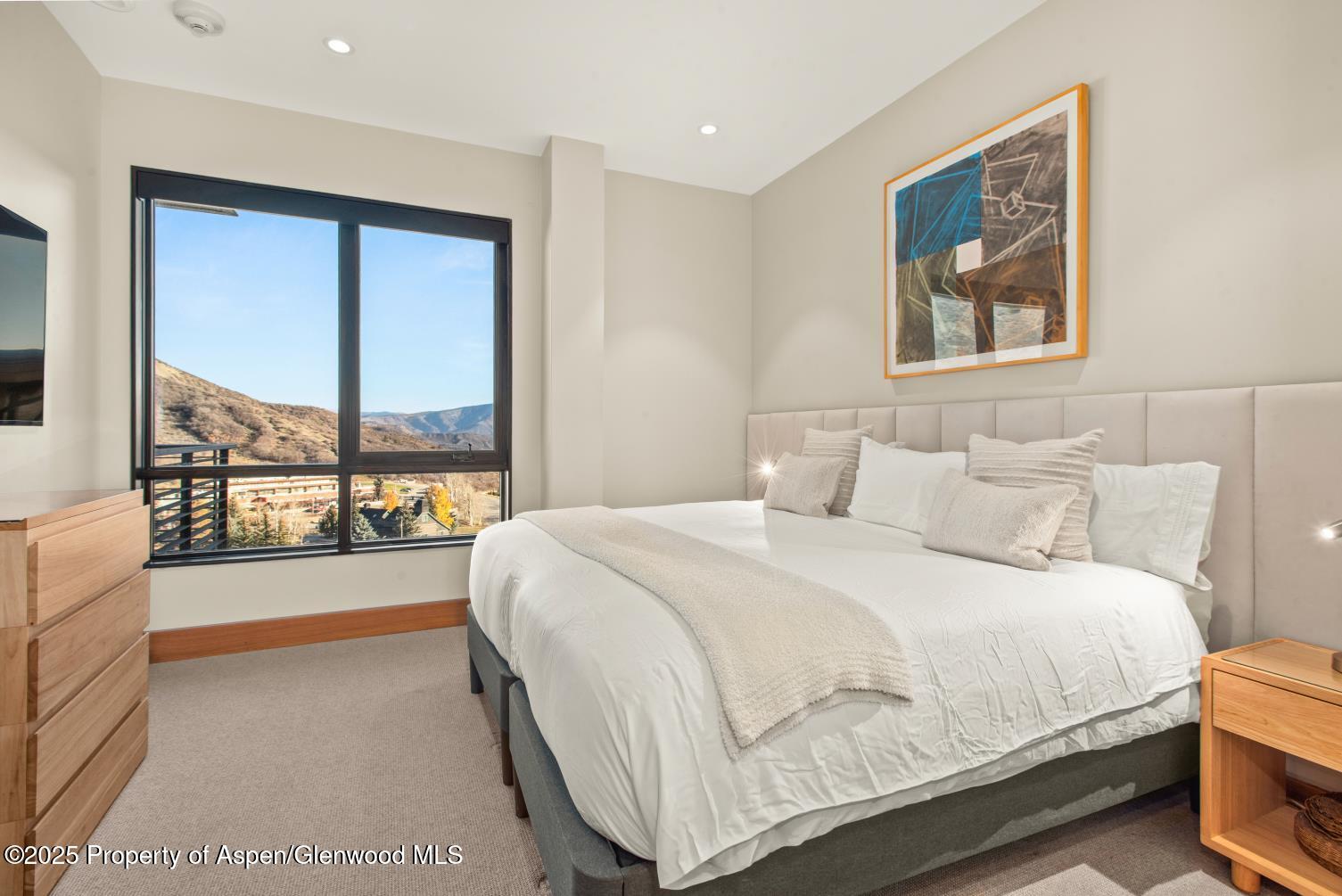 77 Wood Road, Unit 603 Snowmass Village, CO 81615 - Photo 24 of 45 a bedroom with a large bed and a large window