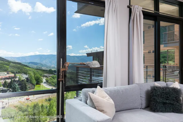 a view of a balcony with furniture and city view
