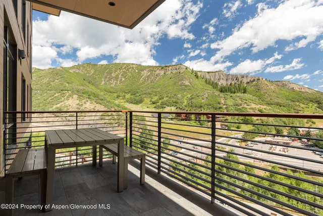 a bedroom with furniture and large window