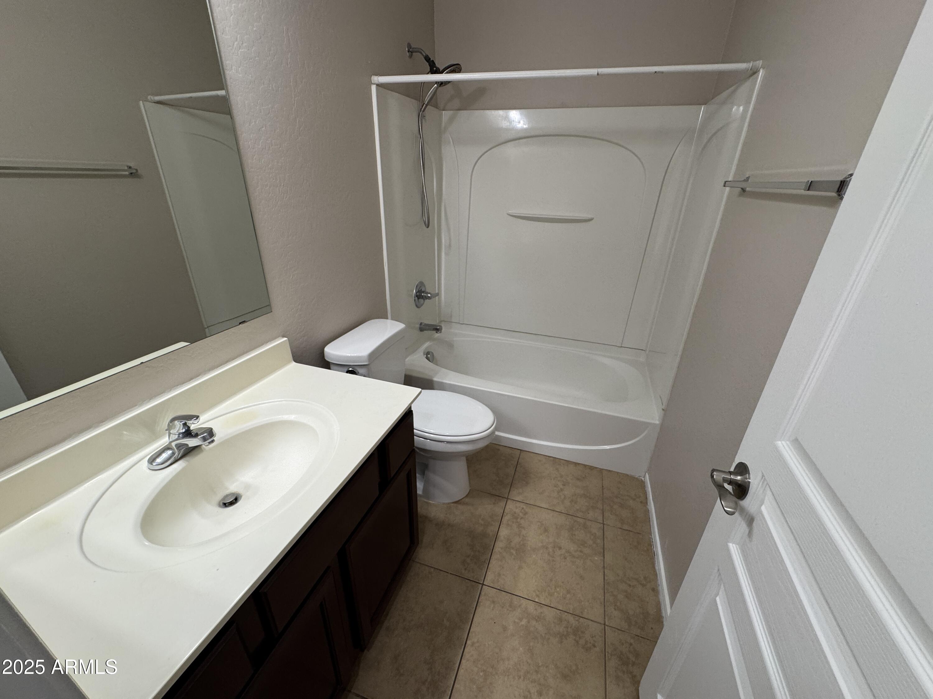 3822 East Santa Fe Lane Gilbert, AZ 85297 - Photo 11 of 24 a bathroom with a sink a toilet and shower