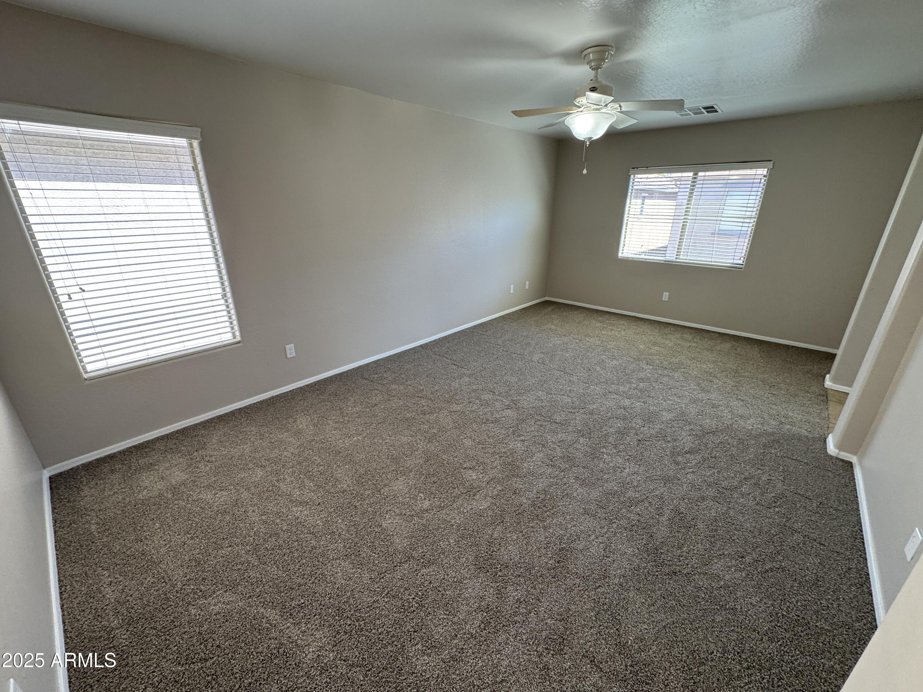 3822 East Santa Fe Lane Gilbert, AZ 85297 - Photo 15 of 24 an empty room with windows and fan