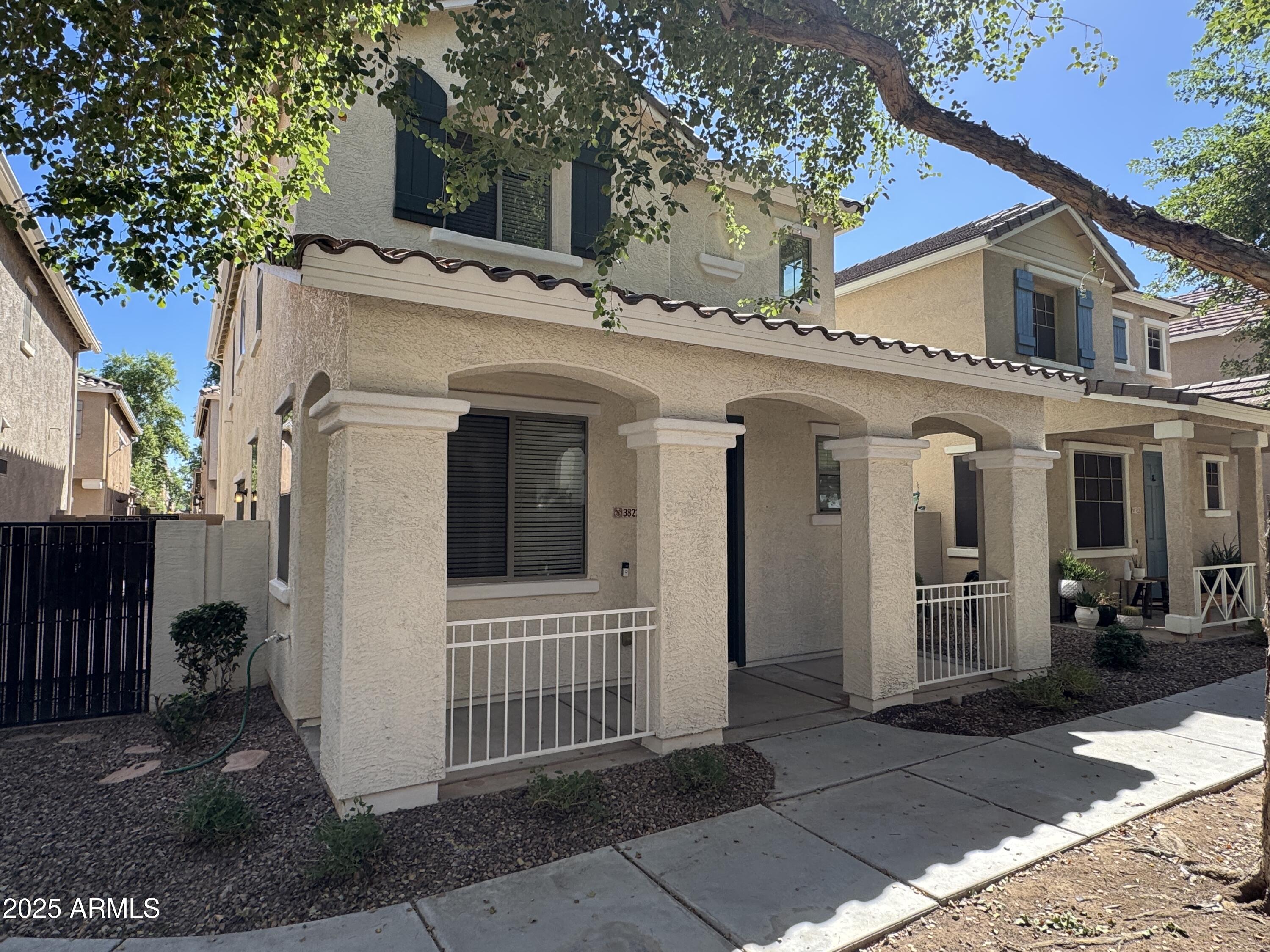 3822 East Santa Fe Lane Gilbert, AZ 85297 - Photo 2 of 24 a view of a house with a small yard and large tree