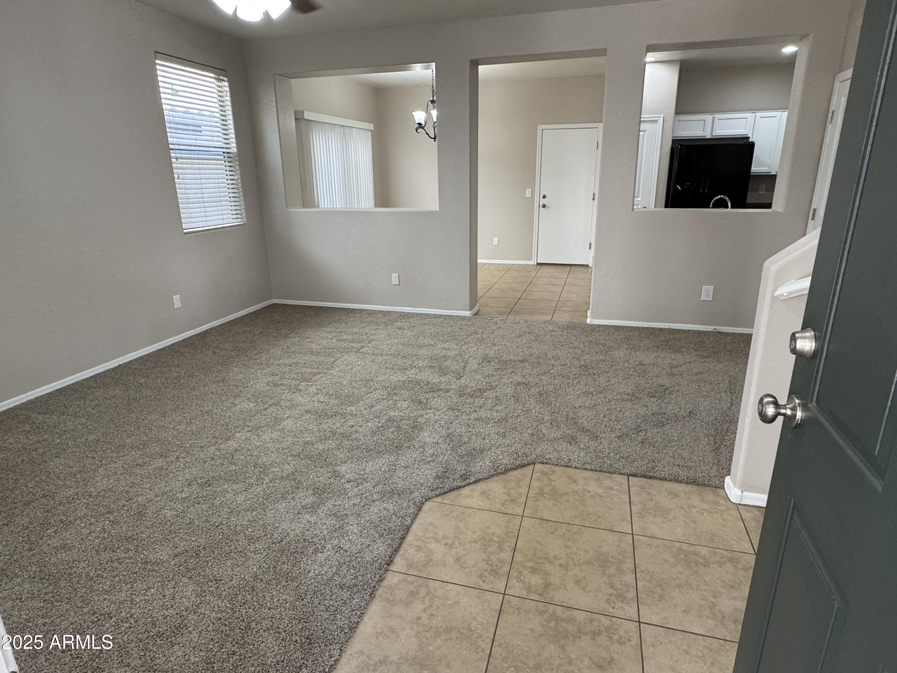 3822 East Santa Fe Lane Gilbert, AZ 85297 - Photo 3 of 24 a view of an empty room with wooden floor and a bathroom