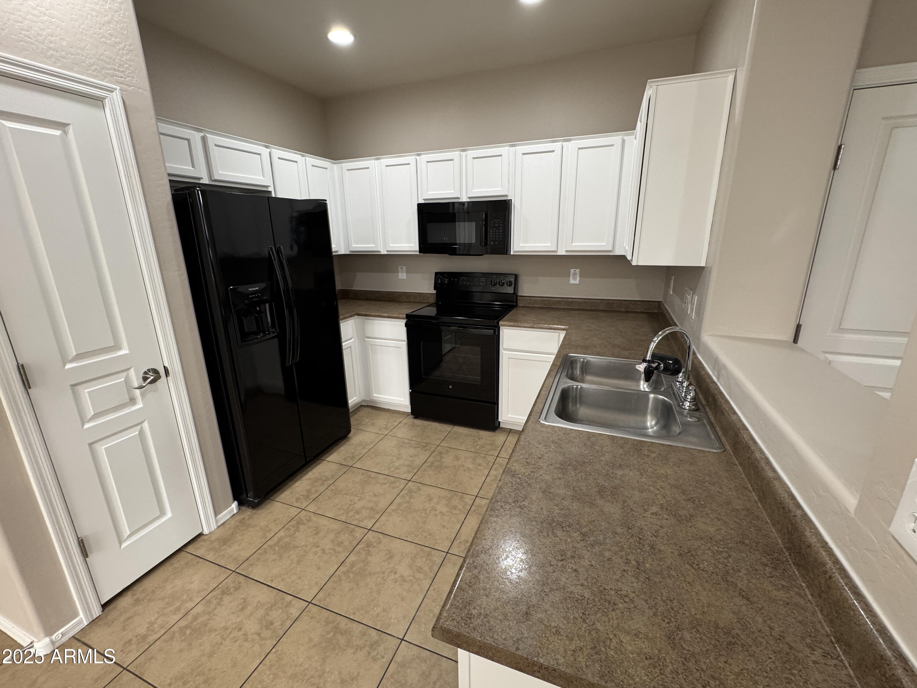 3822 East Santa Fe Lane Gilbert, AZ 85297 - Photo 6 of 24 a kitchen with stainless steel appliances a refrigerator sink and microwave