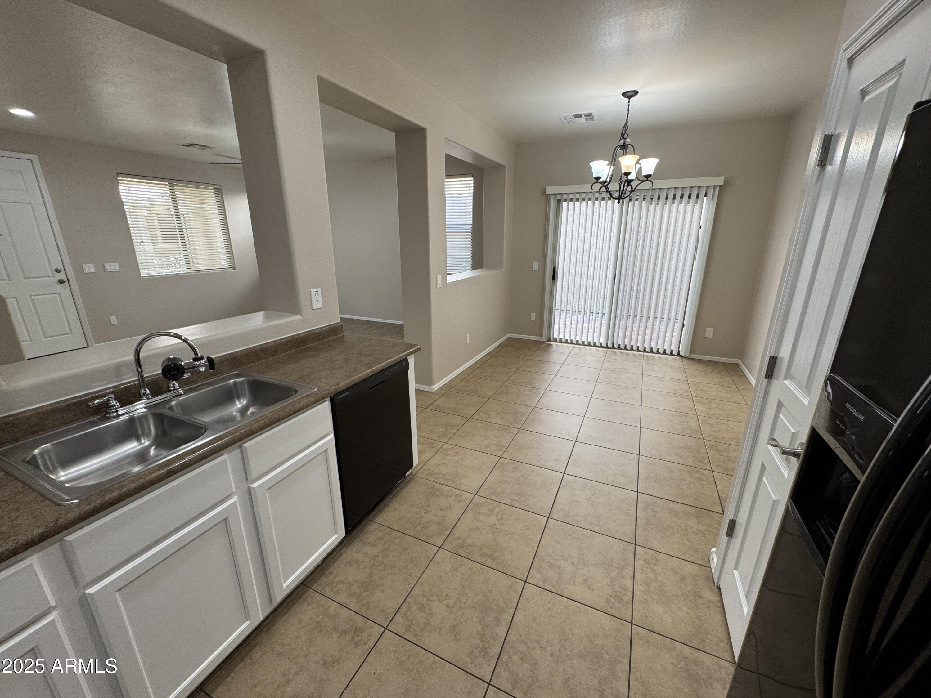 3822 East Santa Fe Lane Gilbert, AZ 85297 - Photo 7 of 24 a kitchen with a sink stove and cabinets