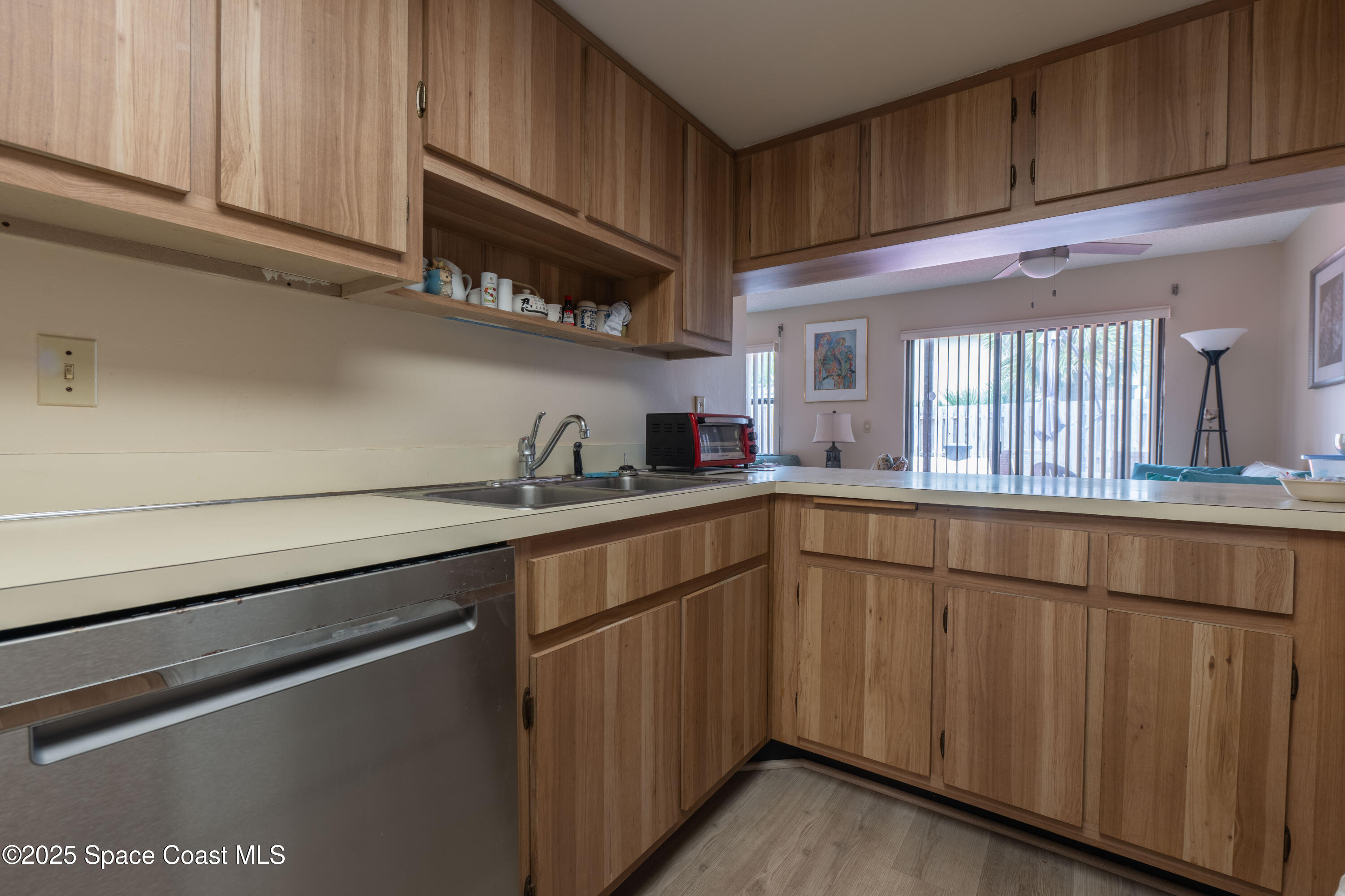 3222 Beach View Way Melbourne Beach, FL 32951 - Photo 11 of 31 a kitchen with stainless steel appliances granite countertop a refrigerator and a sink