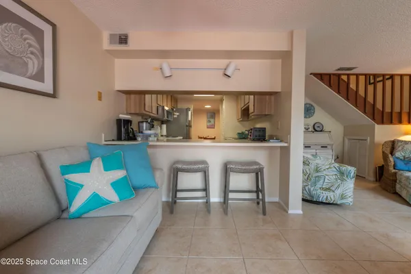 a living room with furniture and kitchen view