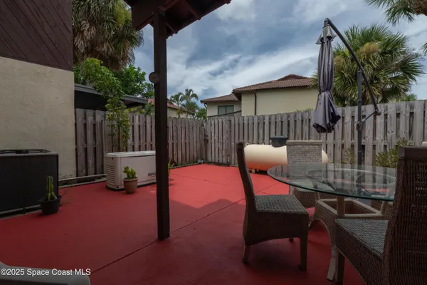 a patio with table and chairs