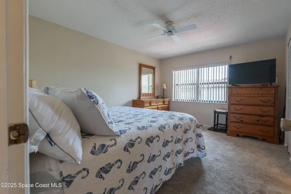 a bedroom with a bed and a television