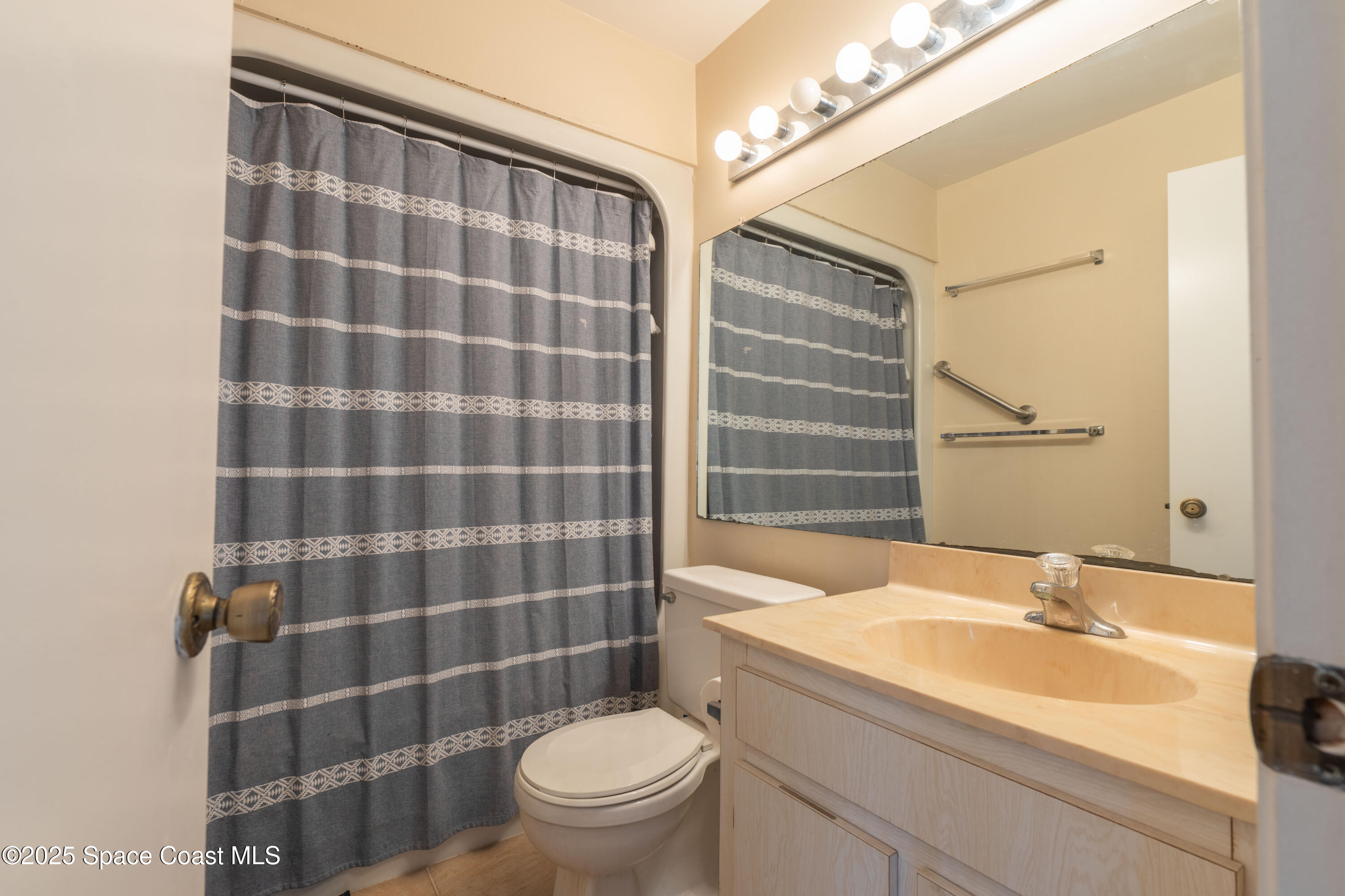 3222 Beach View Way Melbourne Beach, FL 32951 - Photo 21 of 31 a bathroom with a sink toilet and shower
