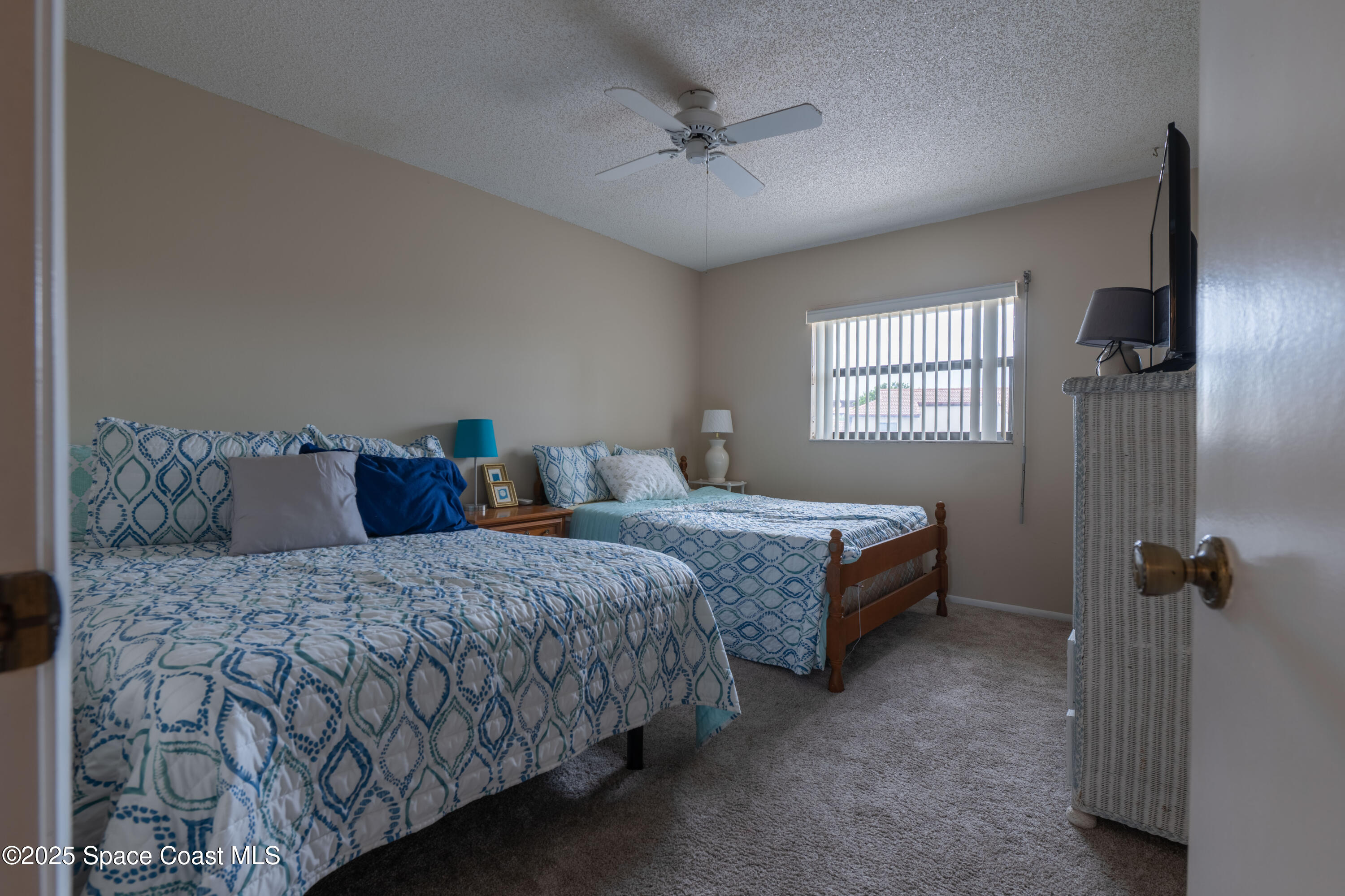 3222 Beach View Way Melbourne Beach, FL 32951 - Photo 22 of 31 a bedroom with two beds and windows